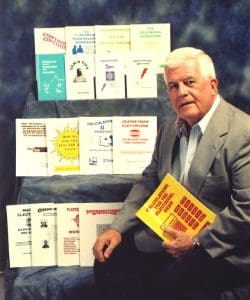 A man in suit and tie holding a book.