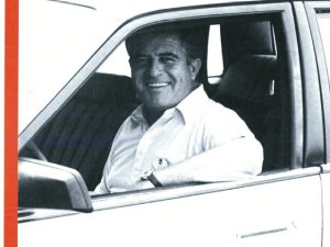 A man sitting in the drivers seat of a car.