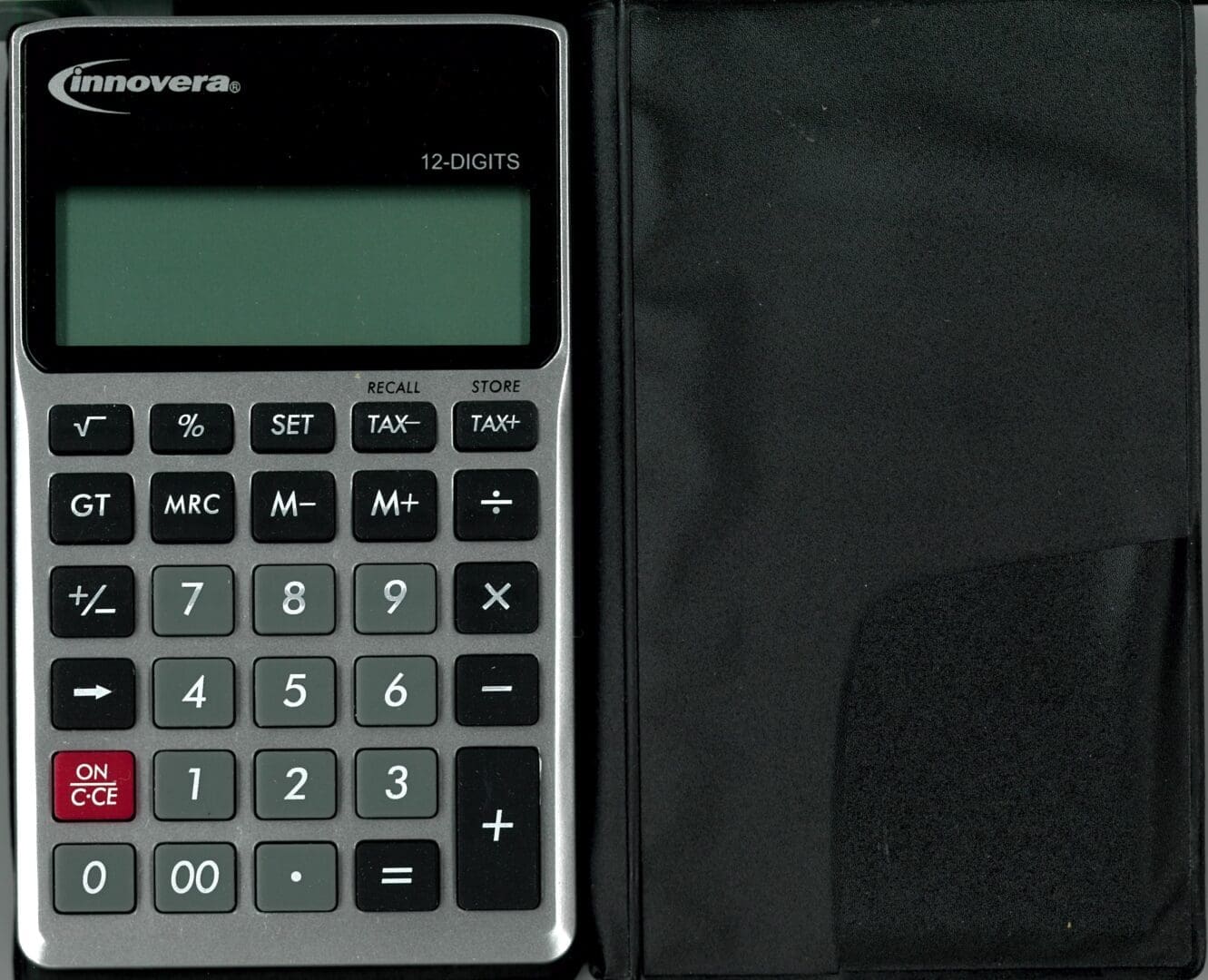 A calculator sitting on top of a book.