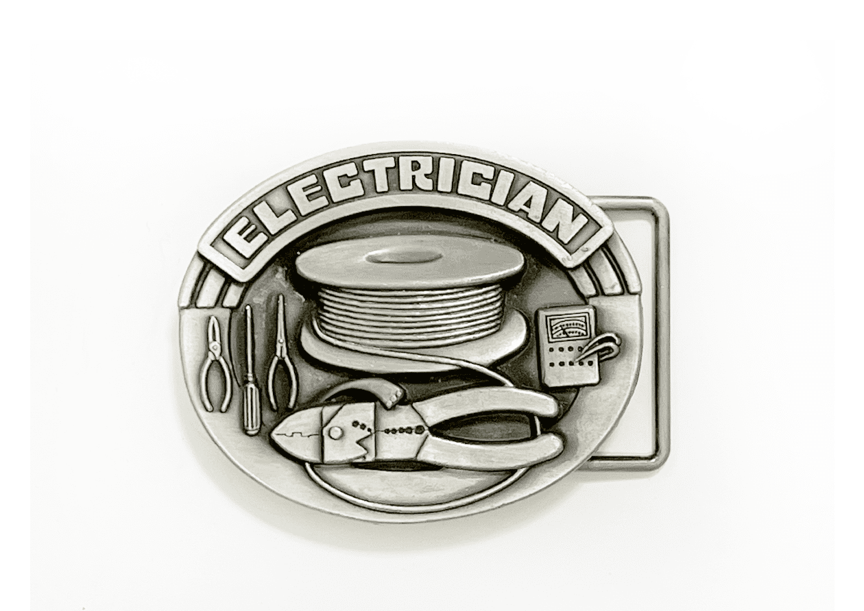 A belt buckle with tools and wires on it.