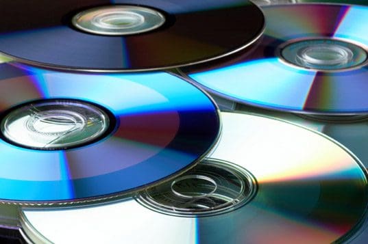 A close up of several cds on top of each other.